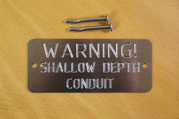 SC-2 - Shallow Depth Conduit Marker - (Code: SC-2), ‘Warning! Shallow Depth Conduit - Engraved Stainless Steel platesUsed by various Councils, Electrical, Communication, civil companies and utilities in all areas, for easy and quick identification & location of underground shallow services and cables. 150 x 65mm by 2mm thick Stainless Steel plate and includes 2 x (5 x 50mm) S/S mushroom head fixing spikes, (for Wet or Dry Concrete). Australia Made