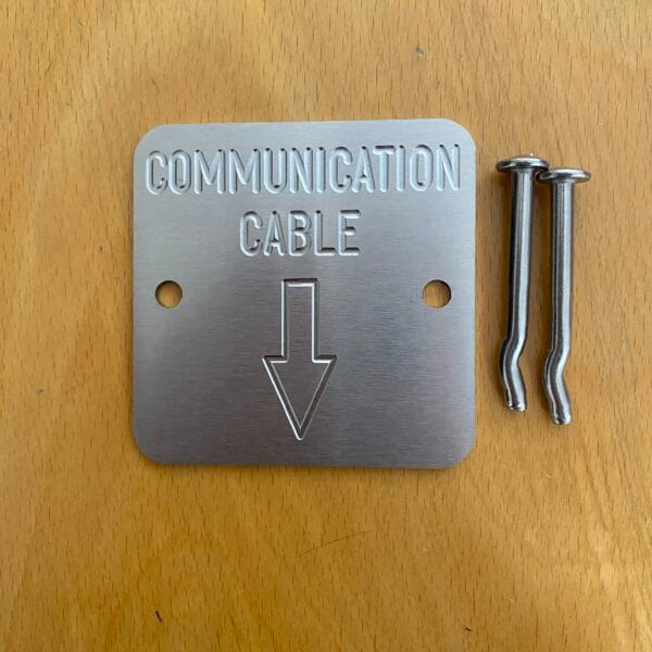 Communication Cable Markers - Engraved identification plates - 'Communication Cables with Arrow Down' (Code; C75-3B). 75 x 75mm by 2mm thick Stainless steel plates. Used by Councils, Communication companies, Civil and utilities. Australian Made. Quality engraved Stainless steel plates / markers - 75 x 75mm by 2mm thick. Includes a 5 x 50mm Stainless steel mushroom head fixing spike, (for Wet or Dry concrete).